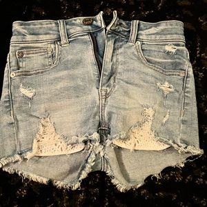 Light denim jean shorts from American Eagle with lace pockets. Size 00